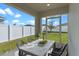 Relaxing screened porch with table and chairs, overlooking fenced backyard at 524 Scenic Bluff Blvd, Lake Wales, FL 33853
