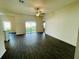 Spacious living area with dark laminate flooring and sliding glass doors at 13489 Leaping Water Way, Astatula, FL 34705