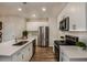 Modern kitchen with white cabinets, stainless steel appliances, and quartz countertops at 3832 King Hill Dr, Haines City, FL 33844