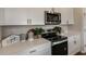 Modern kitchen with white cabinets and stainless steel appliances at 3848 King Hill Dr, Haines City, FL 33844