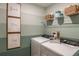 Bright laundry room with washer, dryer, and shelving at 3848 King Hill Dr, Haines City, FL 33844