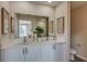 Double vanity bathroom with modern white cabinets and a large mirror at 3856 King Hill Dr, Haines City, FL 33844