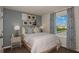 Light and airy bedroom with a queen bed, neutral decor, and a view of the community at 3864 King Hill Dr, Haines City, FL 33844