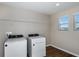 Laundry room with washer, dryer, and overhead shelving at 1422 Derry Ave, Haines City, FL 33844