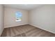 Well-lit bedroom with brown carpet and a window at 1611 Ellesmere Ave, Haines City, FL 33844