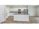 Modern kitchen with white cabinets, stainless steel appliances and island at 1781 Frogmore Ave, Haines City, FL 33844