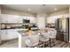 Modern kitchen with white cabinets, stainless steel appliances, and a kitchen island at 1785 Frogmore Ave, Haines City, FL 33844