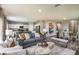 Open concept living room and kitchen area with gray sofa and wood flooring at 4014 Gardenia Ave, Lake Hamilton, FL 33851