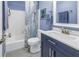 Charming blue bathroom with a shower/tub combo and white vanity at 412 Howard Ave # C, Lakeland, FL 33815