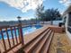 Inviting pool area with wooden deck and steps at 6421 Myrtlewood Dr, Lakeland, FL 33810