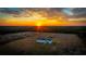 Aerial view of a home on a large lot at sunset at 7435 Postal Colony Rd, Clermont, FL 34714