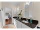 Bathroom with double vanity, granite countertop, and view of bedroom at 7435 Postal Colony Rd, Clermont, FL 34714