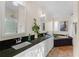 Main bathroom with double sinks, granite countertops, and a soaking tub at 7435 Postal Colony Rd, Clermont, FL 34714