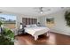 Main bedroom with king-size bed, wood floors, and access to a deck at 7435 Postal Colony Rd, Clermont, FL 34714