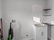 Clean laundry room with a utility sink and shelving at 7435 Postal Colony Rd, Clermont, FL 34714