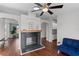 Living area featuring a fireplace, hardwood floors, and access to other rooms at 7435 Postal Colony Rd, Clermont, FL 34714