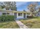 Charming house with gray doors and a neat lawn at 1030 Pineview Pl, Lakeland, FL 33801