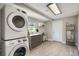 Laundry room with modern washer, dryer, and cabinets at 1030 Pineview Pl, Lakeland, FL 33801