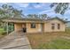 Ranch-style house with carport and mature trees at 3829 Abbott Ln, Lakeland, FL 33810