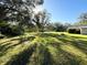 Sunny backyard with expansive lawn and partial shade at 4805 Sand Mountain Loop Rd, Auburndale, FL 33823
