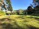 Large backyard with a shed and spacious grassy area at 4805 Sand Mountain Loop Rd, Auburndale, FL 33823