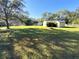 Spacious backyard with lush grass and large oak trees at 4805 Sand Mountain Loop Rd, Auburndale, FL 33823