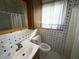 Bathroom with shower, toilet, and white sink at 4805 Sand Mountain Loop Rd, Auburndale, FL 33823