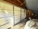 Garage interior with storage and a car covered by a sheet at 4805 Sand Mountain Loop Rd, Auburndale, FL 33823