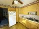 A galley-style kitchen with wood cabinets and tiled floors at 4805 Sand Mountain Loop Rd, Auburndale, FL 33823