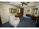 Living room with recliner, ceiling fan, and blue carpet at 4805 Sand Mountain Loop Rd, Auburndale, FL 33823