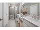 Double vanity bathroom with a frameless shower at 5340 Spoonflower Ct, St Cloud, FL 34771