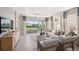 Spacious living room with access to a patio overlooking a pond at 5340 Spoonflower Ct, St Cloud, FL 34771