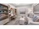 Cozy office or den with built-in shelving and comfortable seating at 5340 Spoonflower Ct, Saint Cloud, FL 34771