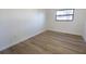 Well-lit bedroom with light wood-look flooring and neutral wall paint at 3203 E Polk Ave, Lakeland, FL 33803