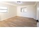 Bright bedroom featuring light wood-look flooring and neutral walls at 3203 E Polk Ave, Lakeland, FL 33803