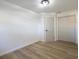 Bright bedroom with wood-look floors and neutral walls, closet, and ensuite bathroom at 3203 S Polk Ave, Lakeland, FL 33803