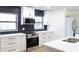Modern kitchen with white cabinets, quartz countertops and herringbone tile backsplash at 3203 S Polk Ave, Lakeland, FL 33803