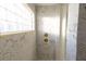 Bright shower with marble tile and a block window at 3203 S Polk Ave, Lakeland, FL 33803