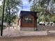 Log cabin home with stone wall and paved area at 25232 Ne 142Nd St, Fort Mc Coy, FL 32134