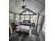 Sunroom with gray couch, coffee table, and ceiling fan at 25232 Ne 142Nd St, Fort Mc Coy, FL 32134