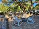 Fire pit and rocking chairs on paved patio at 25232 Ne 142Nd St, Fort Mc Coy, FL 32134