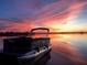 Pontoon boat on calm lake at sunset at 25232 Ne 142Nd St, Fort Mc Coy, FL 32134