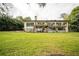 Backyard showcasing a two-story house with a deck and lush lawn at 1212 Lake Point Dr, Lakeland, FL 33813