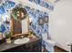 Bathroom featuring bold blue floral wallpaper and a dark vanity at 1212 Lake Point Dr, Lakeland, FL 33813