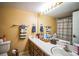 Bathroom with white countertop, wooden cabinets, and shower/tub combo at 1212 Lake Point Dr, Lakeland, FL 33813