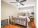 Cozy bedroom with parquet floors, ceiling fan, and unique wall decor at 1212 Lake Point Dr, Lakeland, FL 33813