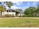 Charming single-story home with lush landscaping and palm trees at 1212 Lake Point Dr, Lakeland, FL 33813