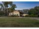 Exterior view at dusk highlighting the home's architecture, illuminated windows, and inviting entryway at 1212 Lake Point Dr, Lakeland, FL 33813