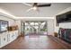 Gathering room with brick floors, fireplace, and sliding doors to the patio at 1212 Lake Point Dr, Lakeland, FL 33813
