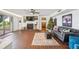 Cozy living room with a fireplace, brick floors, and sliding doors at 1212 Lake Point Dr, Lakeland, FL 33813